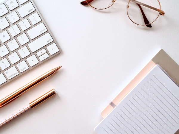 A keyboard notepad and glasses